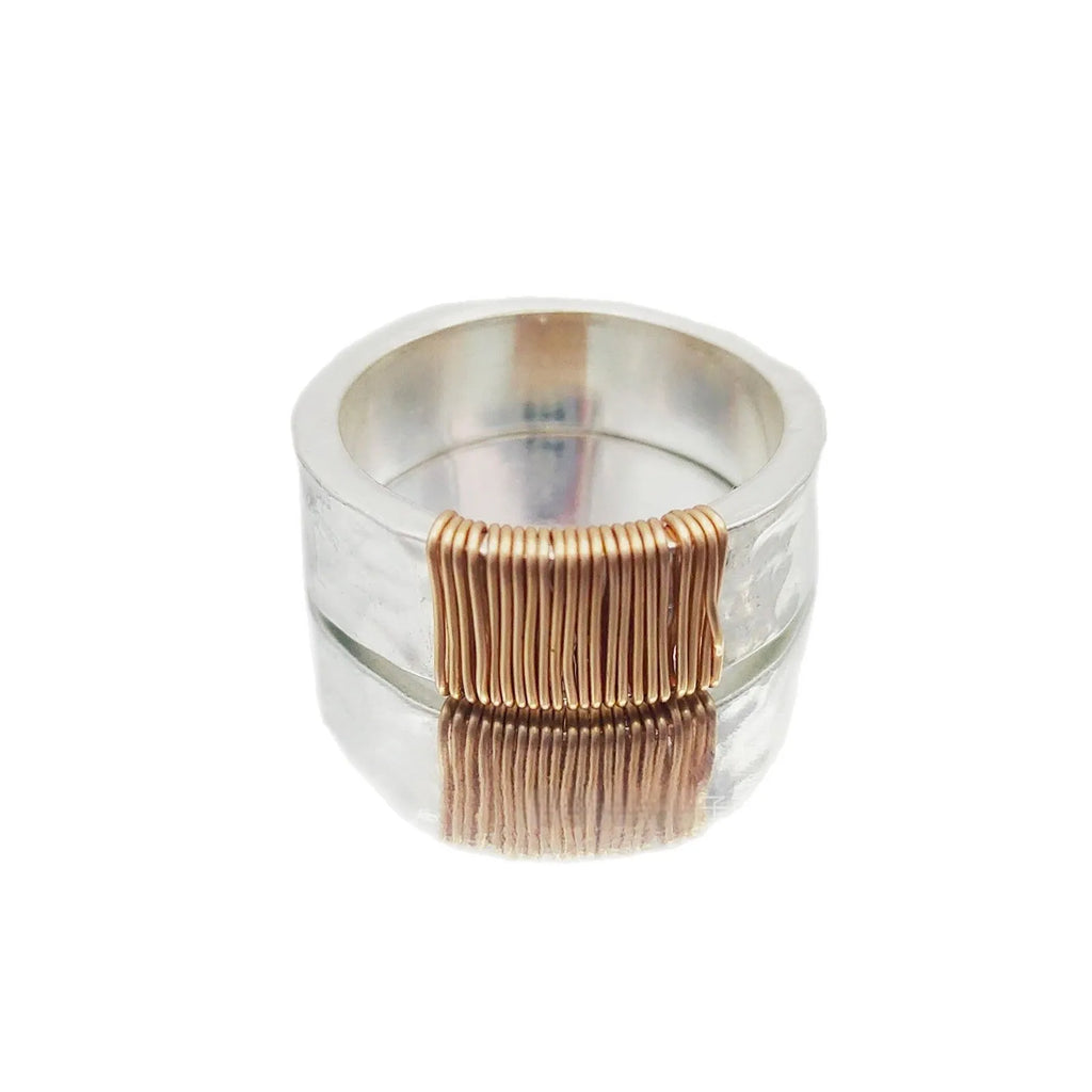 Simple geometric ring bracelet in electroplated copper with silver gold coil finish showing irregular coil design