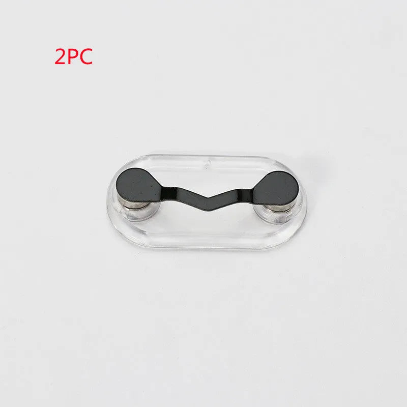 Black magnetic glasses holder attached to car dashboard with spectacles stored on bracket