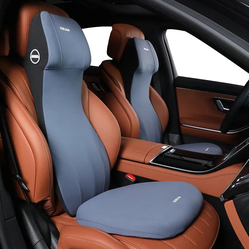 Black integrated memory foam car cushion and lumbar support pillow on a car seat.