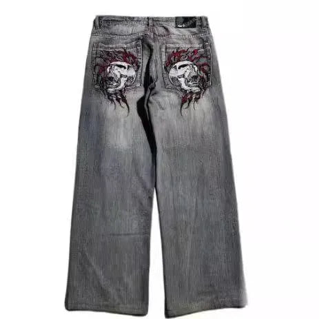 Grey washed-out denim jeans on a man, showing wide-leg straight cut and mid-waist fit.