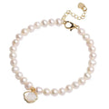 Close-up of a women's freshwater pearl fan bracelet on a wrist, showing elastic string and chain fastening options.