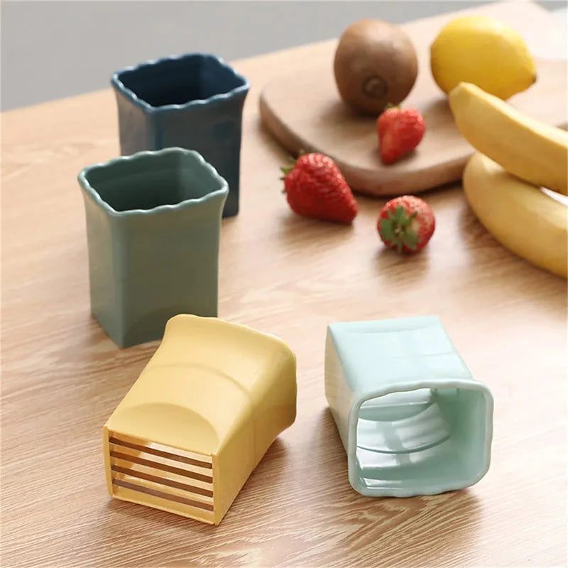 Green stainless steel cup slicer for fruit and vegetable cutting with compact design and visible blade area