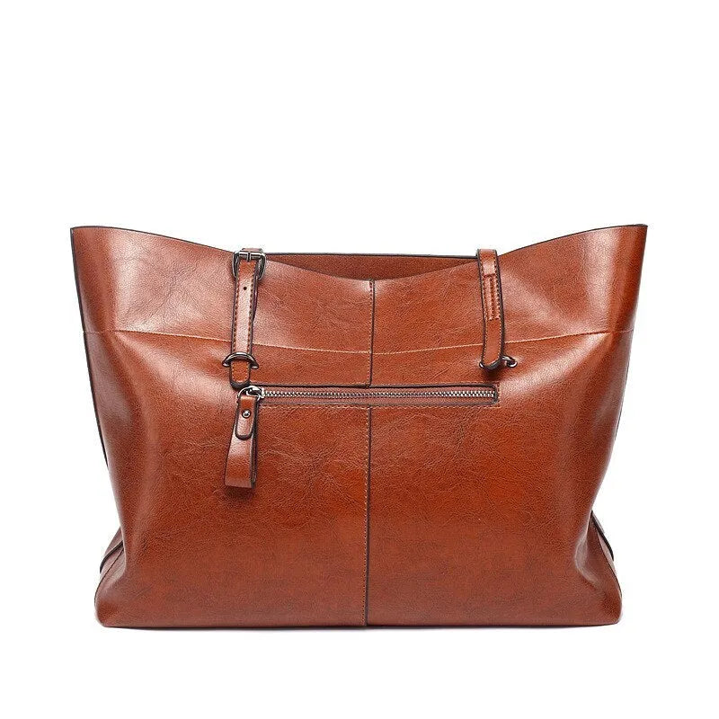 Horizontal leather crossbody handbag in waxed cowhide with two main compartments and a phone pouch.