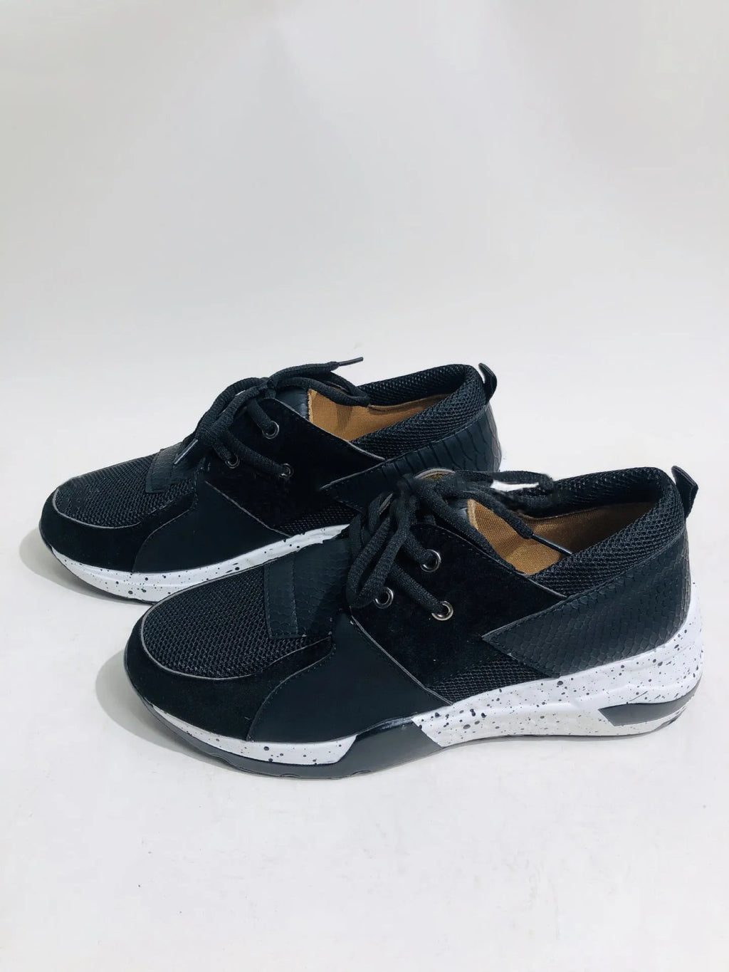 Women's black suede casual sneakers with a wedge heel and round toe on a white background.