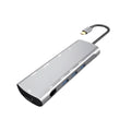 Grey aluminium USB-C docking station showing HDMI, VGA, USB 3.0, PD charging, and card reader ports.