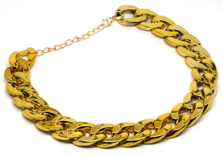 Gold chain dog collar necklace with a geometric buckle on a small dog