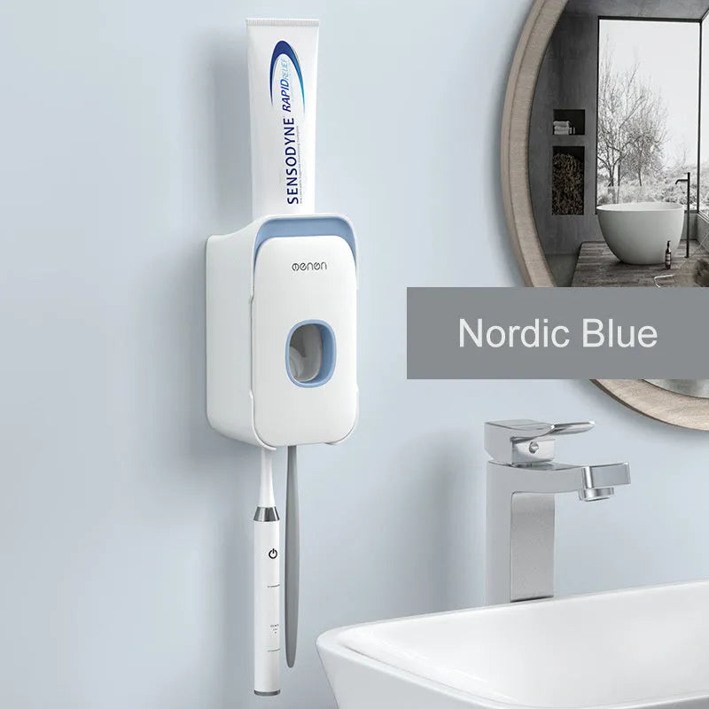 Blue automatic toothpaste dispenser mounted on a bathroom wall with a transparent window showing paste inside.
