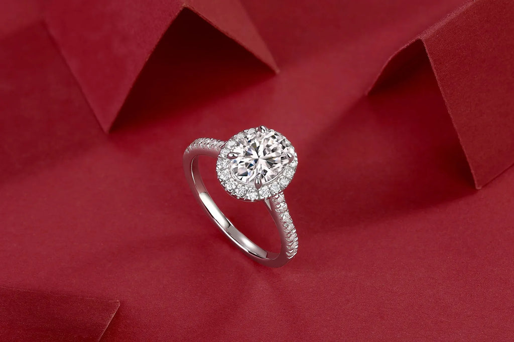 Egg-shaped 7x9mm moissanite wedding ring in S925 silver with platinum plating on white background