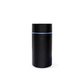 USB ultrasonic aroma diffuser 80ml with RGB LED lights in black, on a desk next to essential oil bottles