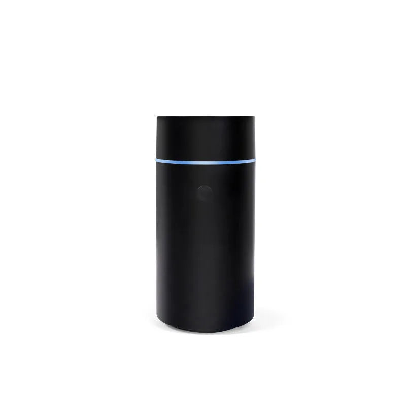 USB ultrasonic aroma diffuser 80ml with RGB LED lights in black, on a desk next to essential oil bottles