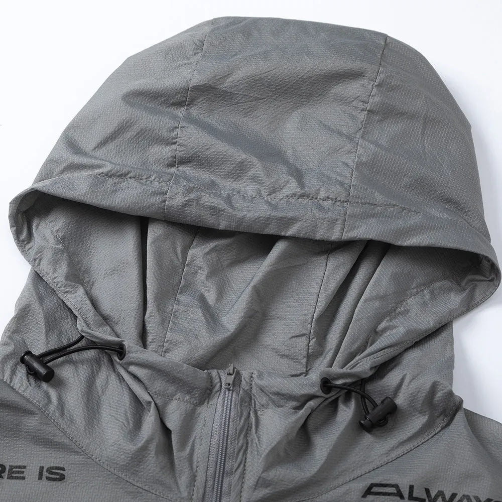 Men's nylon sun protection jacket with letters print in gray, shown on a model