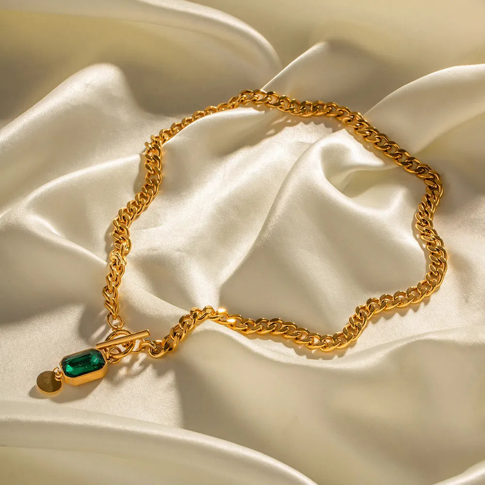 Gold geometric round zircon pendant necklace on a titanium steel Cuban link chain.