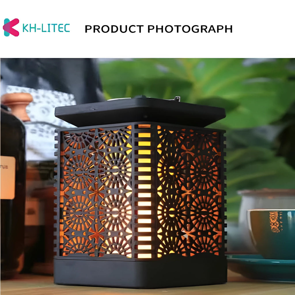 Set of four black solar-powered hanging lanterns with flickering flame LED lights for outdoor garden decoration.