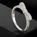 Silver bow-shaped ring with rhinestone detailing, shown in electroplated finish