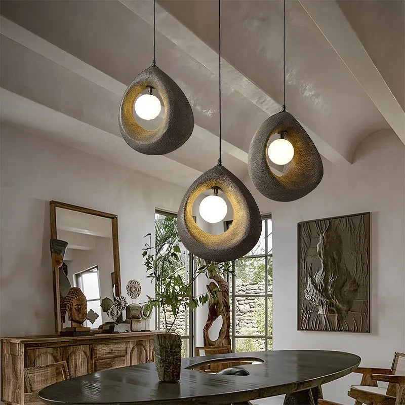 Modern pendant ceiling light with a wide milky white glass shade in a retro chandelier style.