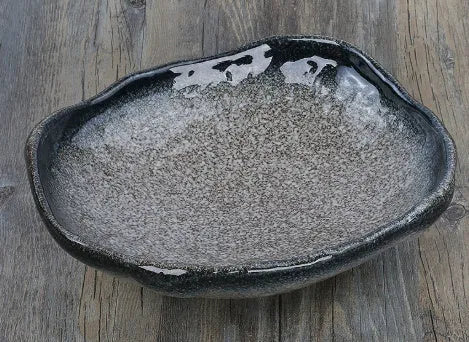 Irregular shaped Japanese coarse pottery bowl with floral decoration measuring 24cm length