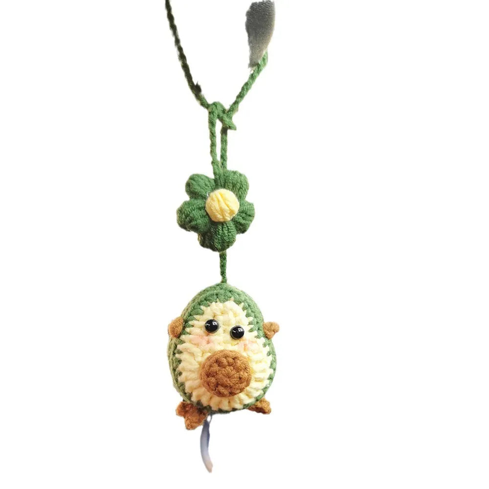 Handmade crocheted rainbow flower car pendant in wool yarn with avocado, pink, and red colour options