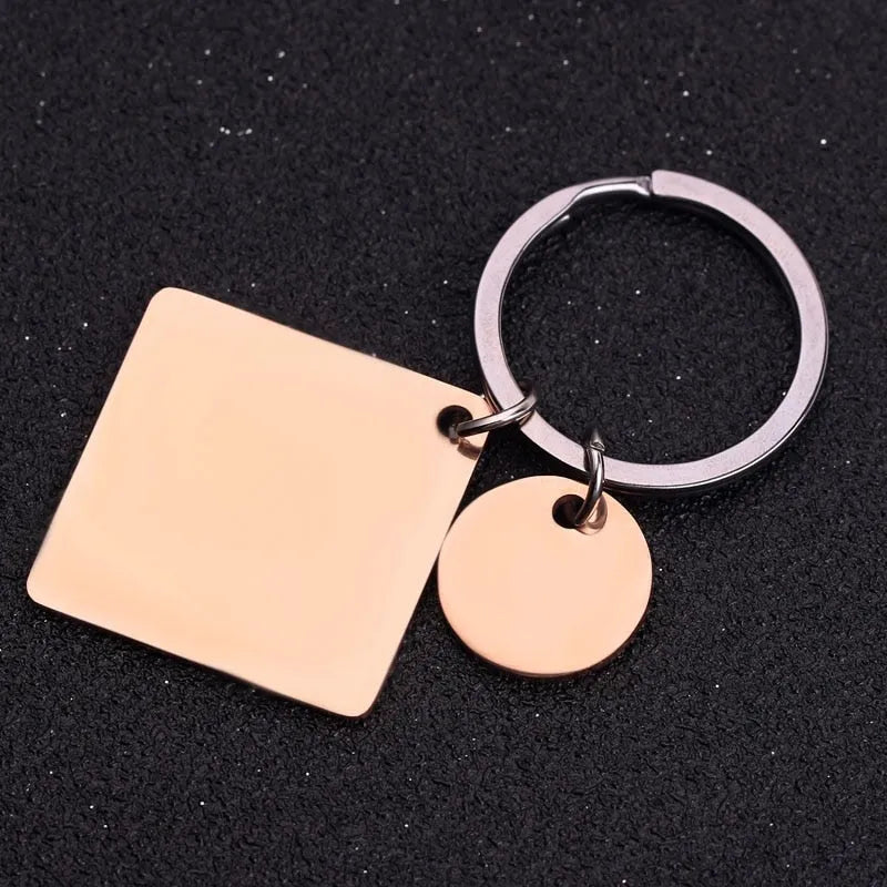 Stainless steel calendar keychain with custom engraved date in silver finish on neutral background