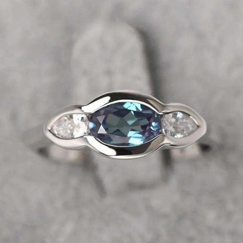 Women's geometric ellipse ring with inlaid zircon stones in white gold finish showing angular design details