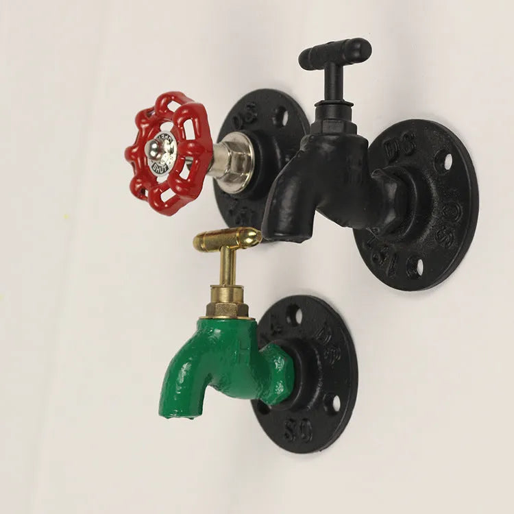 Modern minimalist metal towel rack hook mounted on a wall, shown in black faucet finish.