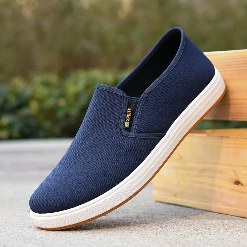 Men's low-top canvas slip-on cloth shoes in black or blue with round toe and composite sole