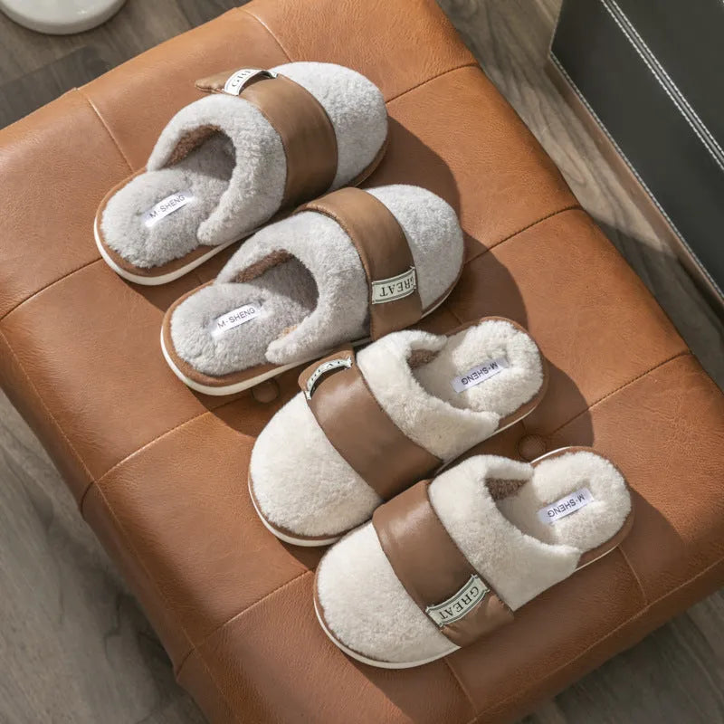 Women's beige plush slipper with Velcro strap and non-slip plastic sole on a wooden floor.