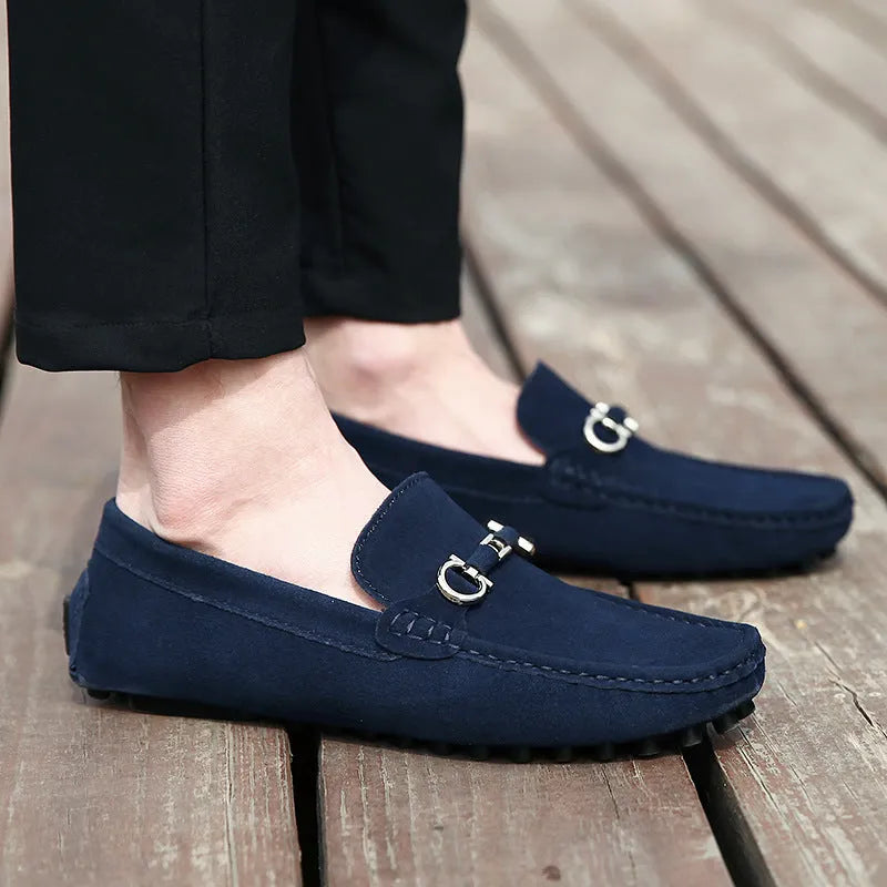 Men's black cowhide leather slip-on shoes with square toe and visible stitching on a rubber sole.