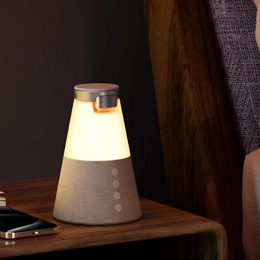 Grey 3-in-1 magnetic wireless charging Bluetooth speaker night light on a tabletop