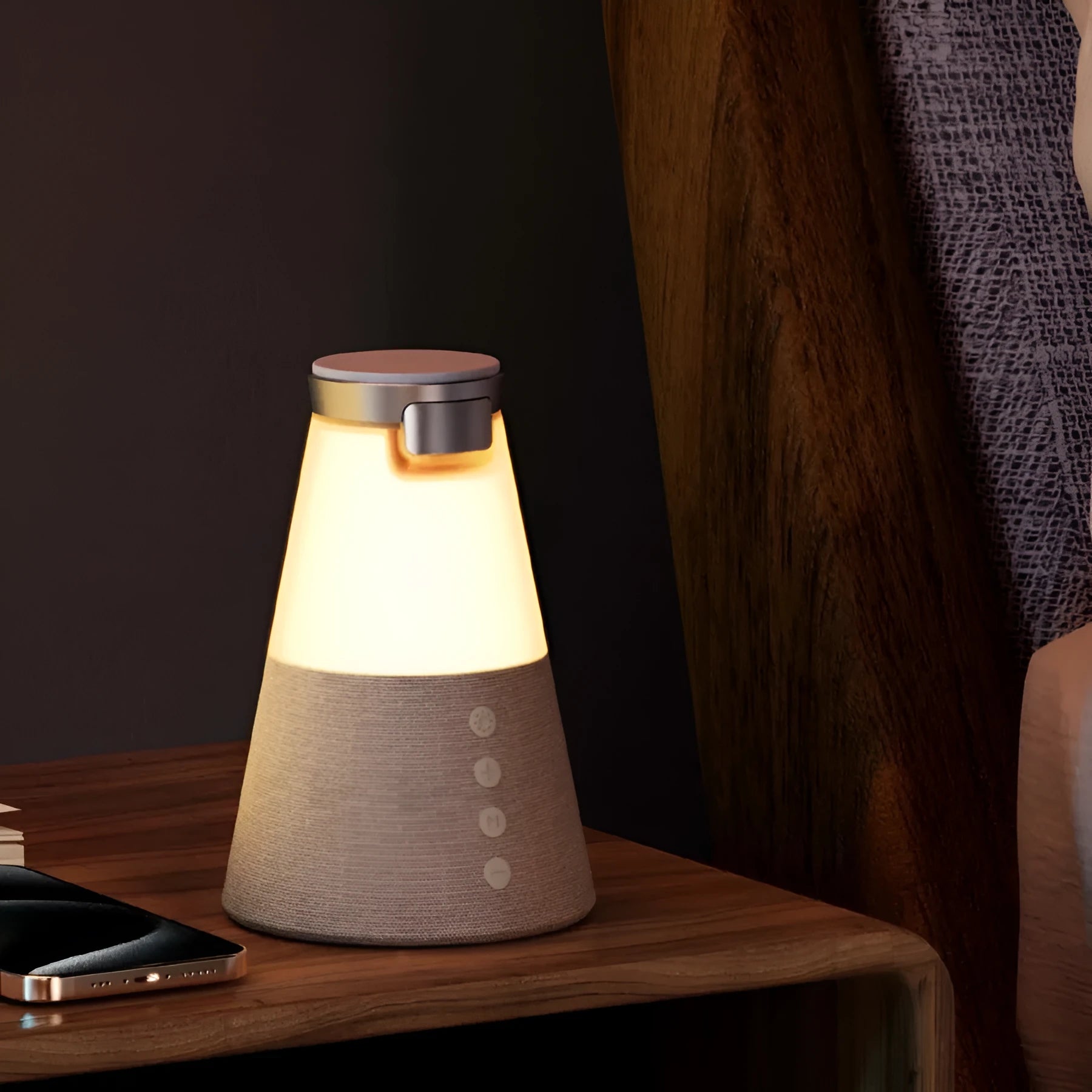 Grey 3-in-1 magnetic wireless charging Bluetooth speaker night light on a tabletop