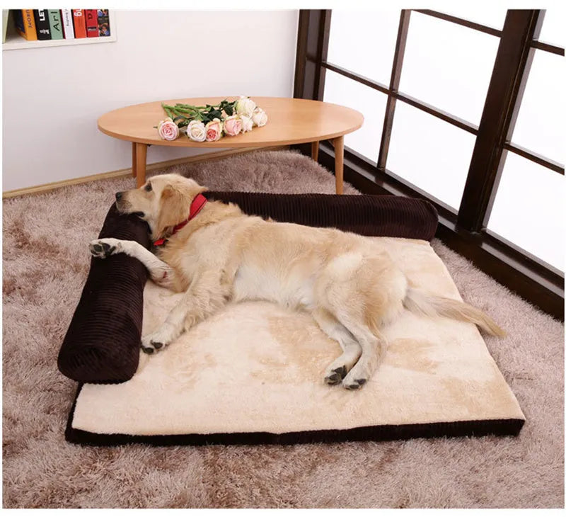 Corduroy pet sofa dog bed with bolster sides, shown in grey colour on a wooden floor