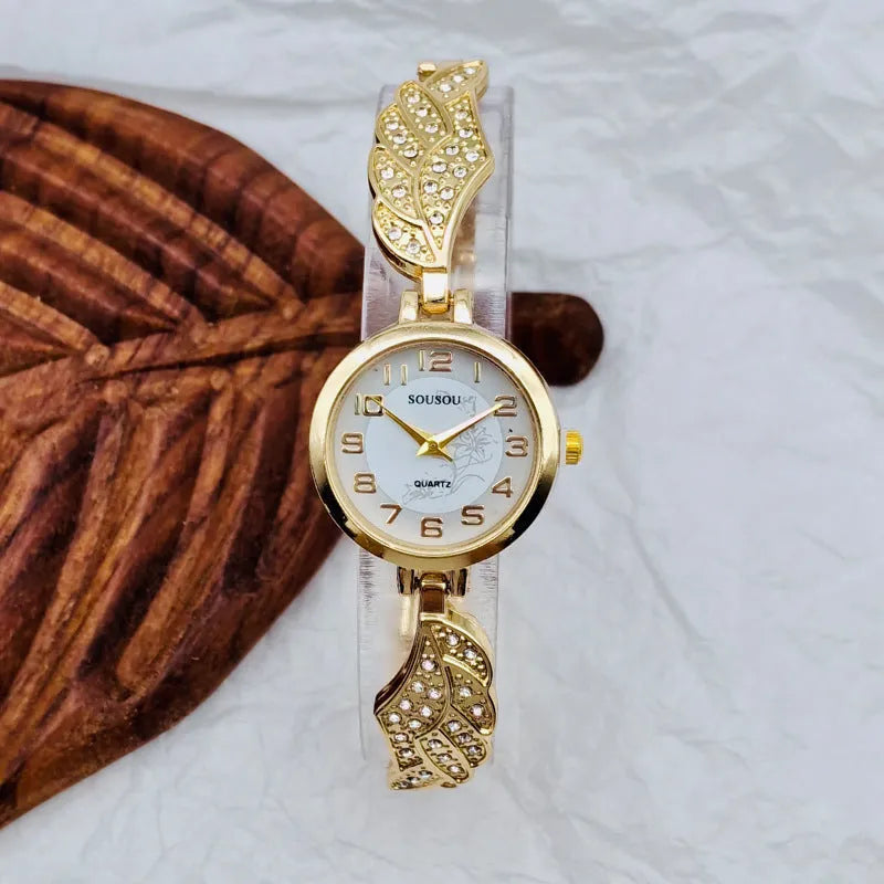 Women's stainless steel watch with round dial showing gold face colour option on wrist.