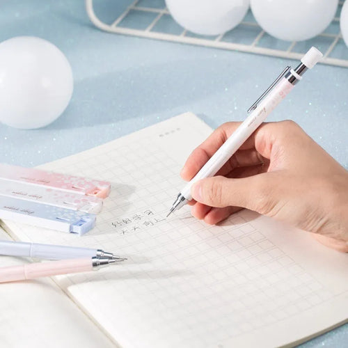 Mixed colour 0.5mm cartoon propelling pencils and HB refill boxes set on a white surface.