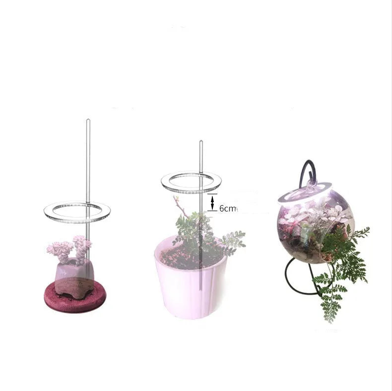 USB full spectrum LED plant grow light with acrylic stick on a table next to houseplants.