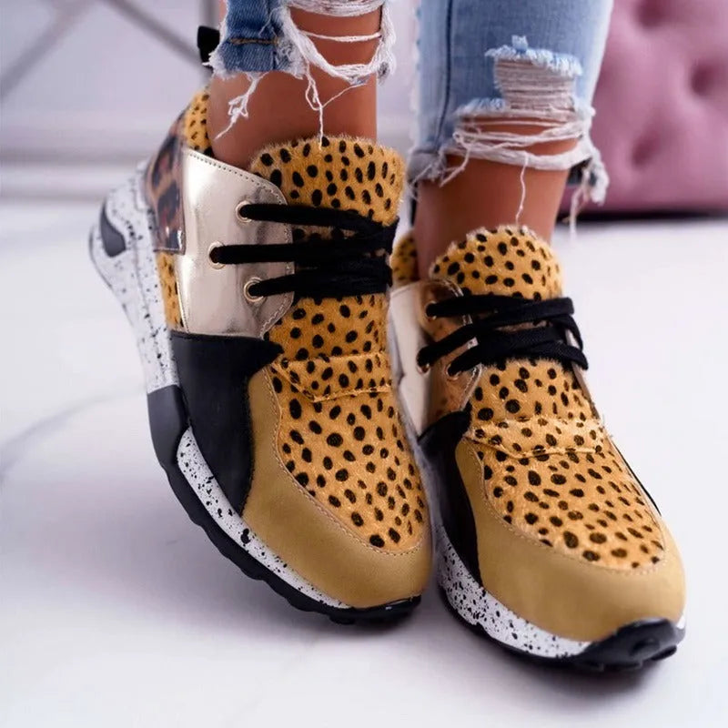 Women's black suede casual sneakers with a wedge heel and round toe on a white background.