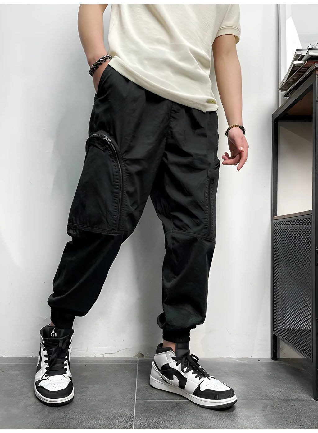 Men's loose-fit cotton cargo trousers with elastic waist, zipper, and multiple big pockets in army green