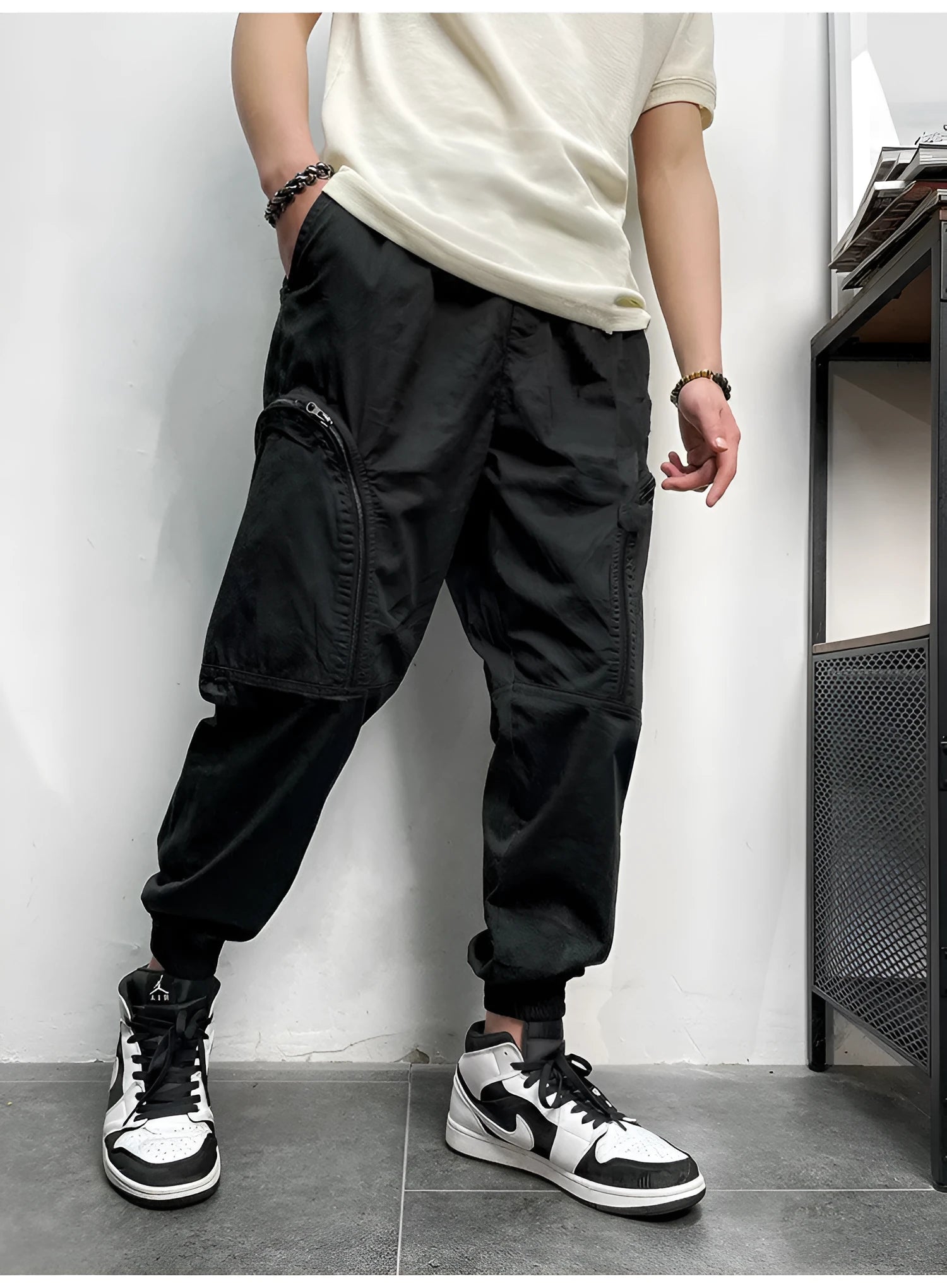 Men's loose-fit cotton cargo trousers with elastic waist, zipper, and multiple big pockets in army green