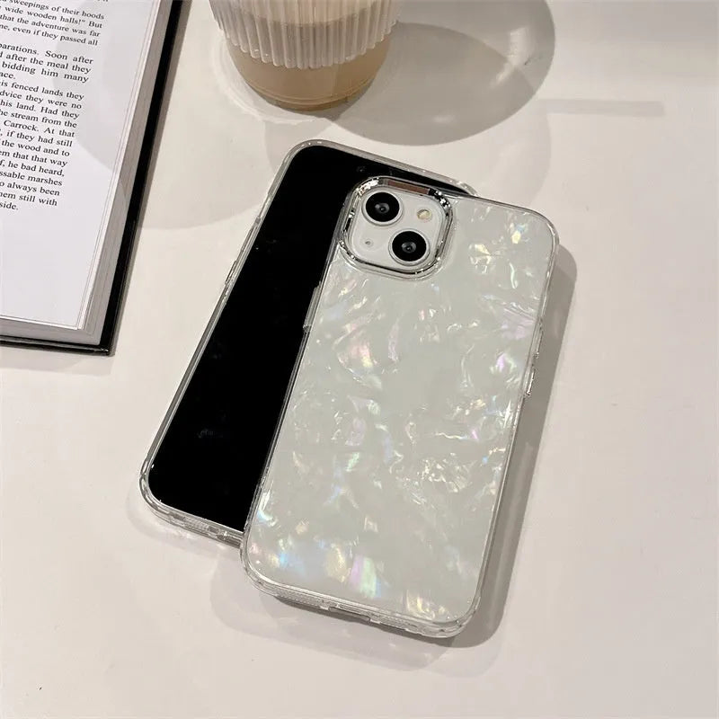 White TPU phone case with fantasy shell pattern compatible with iPhone 13 showing back design and side buttons