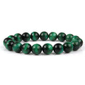 Natural tiger eye crystal bracelet with round beads in various colours on a wrist.