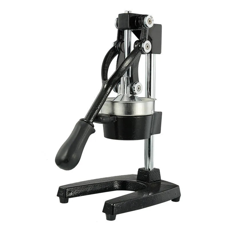 Black cast iron manual juice extractor with stainless steel strainer on a kitchen counter.