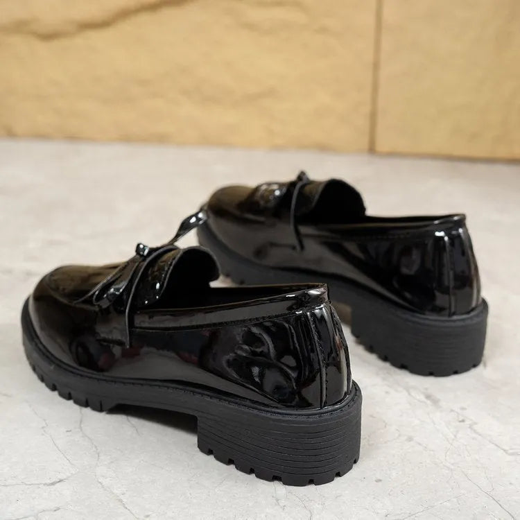 Women's black and brown casual loafers with a decorative bow on the artificial PU upper.