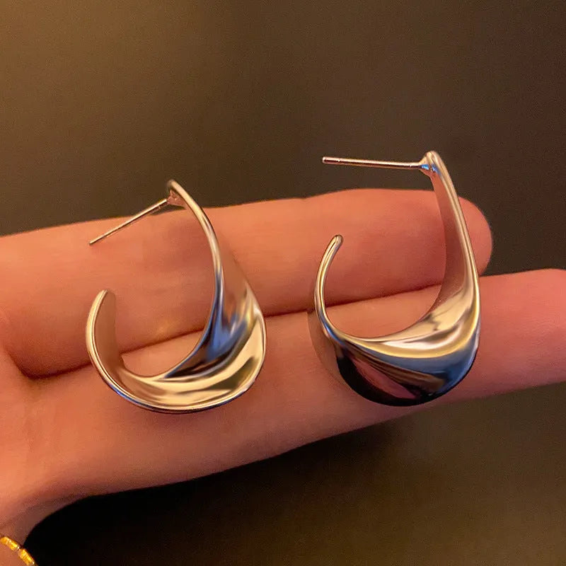 Metal twisted geometric earrings with round elements in gold or silver electroplated finish