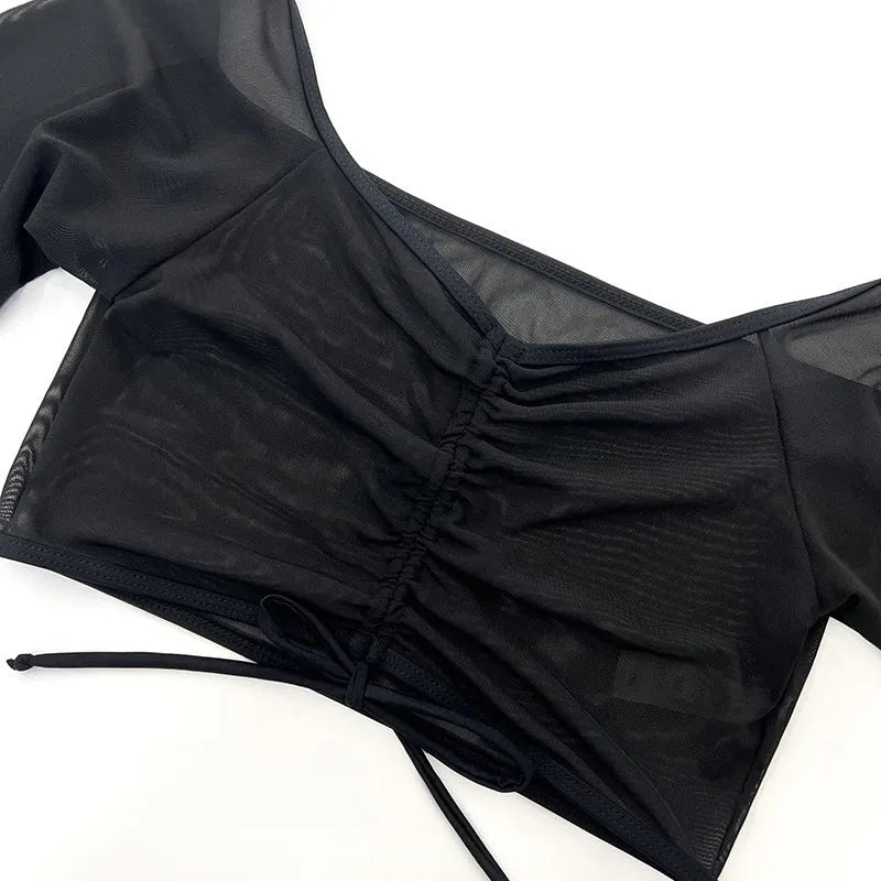Black long sleeve mesh top and briefs from a women's four-piece bikini swimwear set.