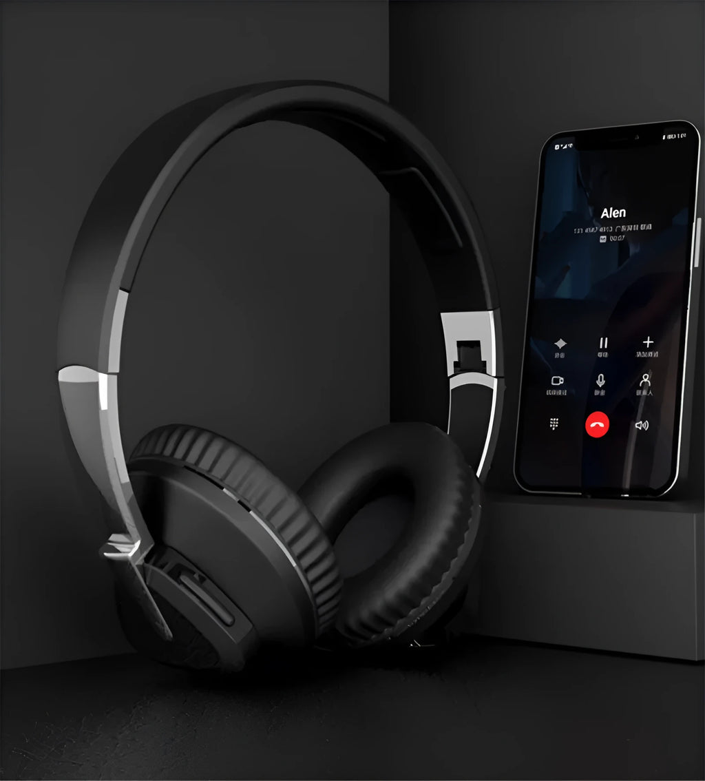 Wireless over-ear headset in black with soft ear cushions, showing AUX audio jack port.