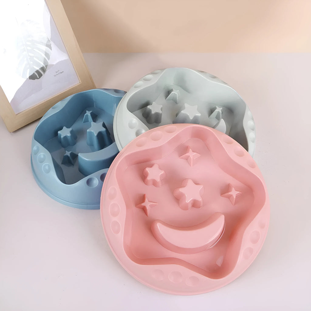 Large blue slow feeder dog bowl with raised moon and star wing patterns and a non-slip rubber base.