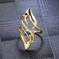 Gold copper women's ring with exaggerated curve silhouette and zircon sparkle on finger