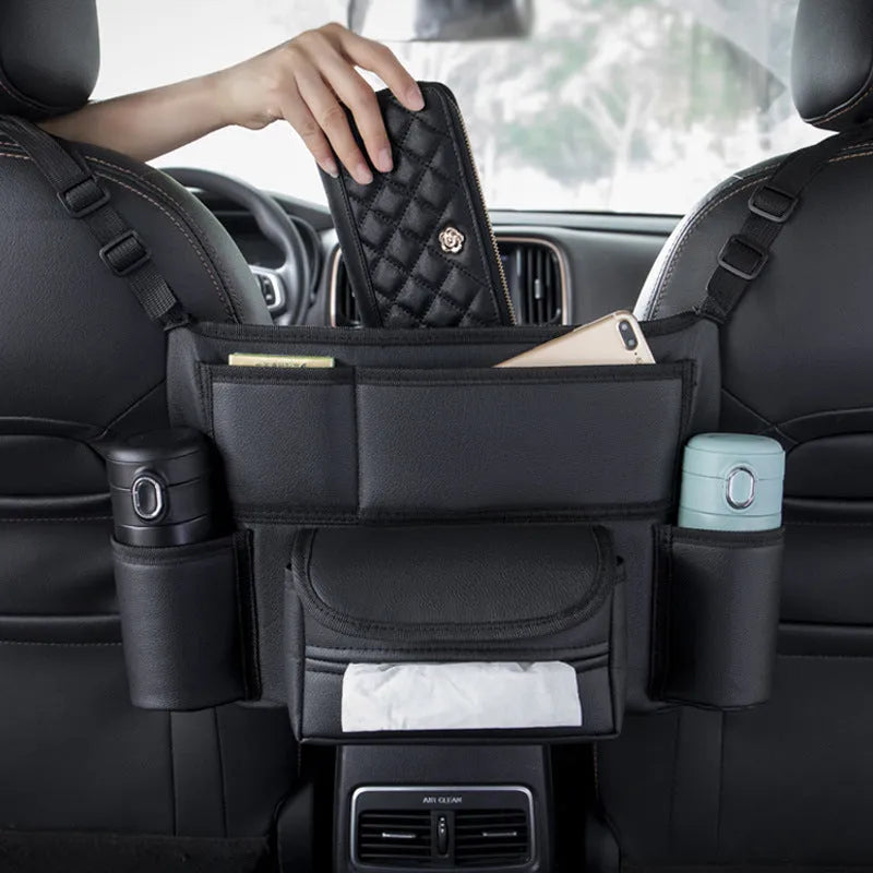 Black leather car seat organiser tissue box holder hanging between front seats