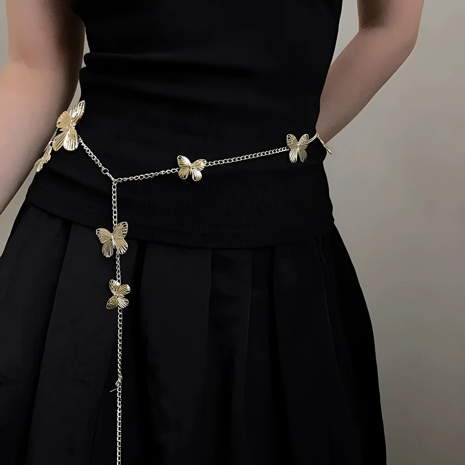 Gold or silver alloy butterfly waist chain belt showing 104cm length and decorative charm.
