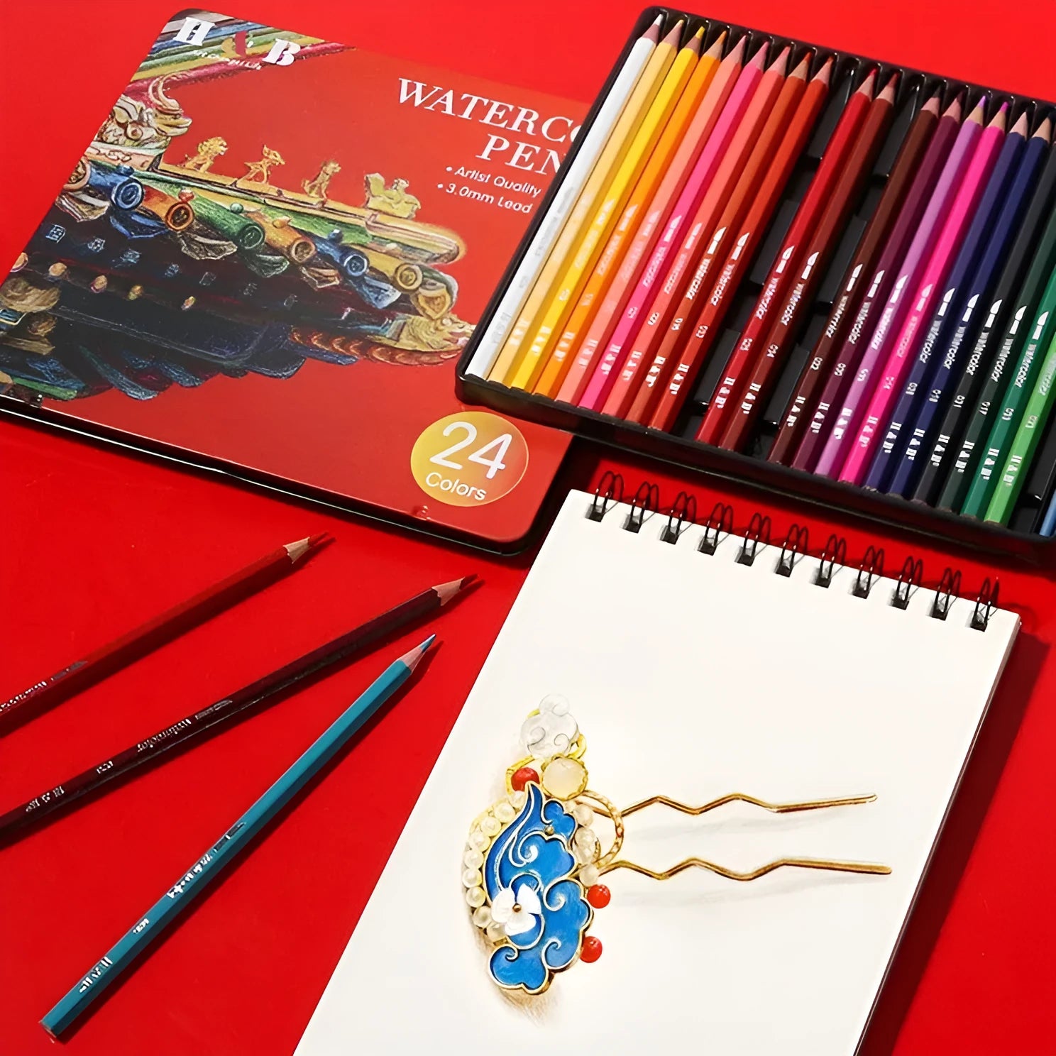 Water-soluble coloured pencil set with 24 colours and a brush in a black iron box.