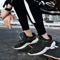 Low-top adult running shoes in a plain style with a front strap and mesh upper.