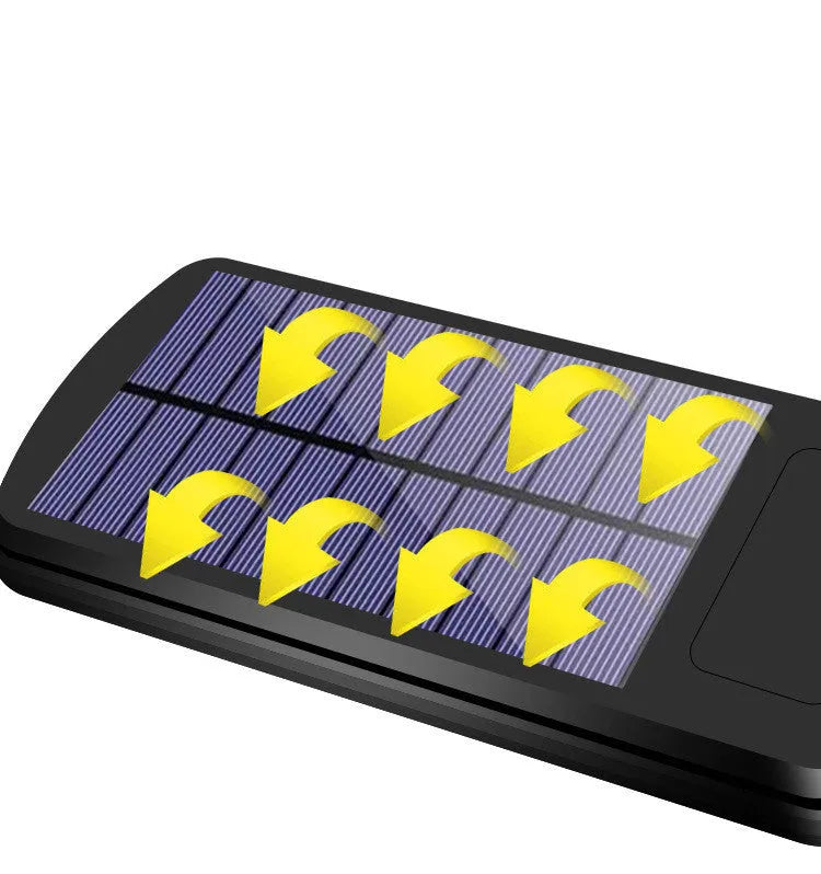 Black solar powered outdoor motion sensor light with solar panel for garden fence or driveway illumination
